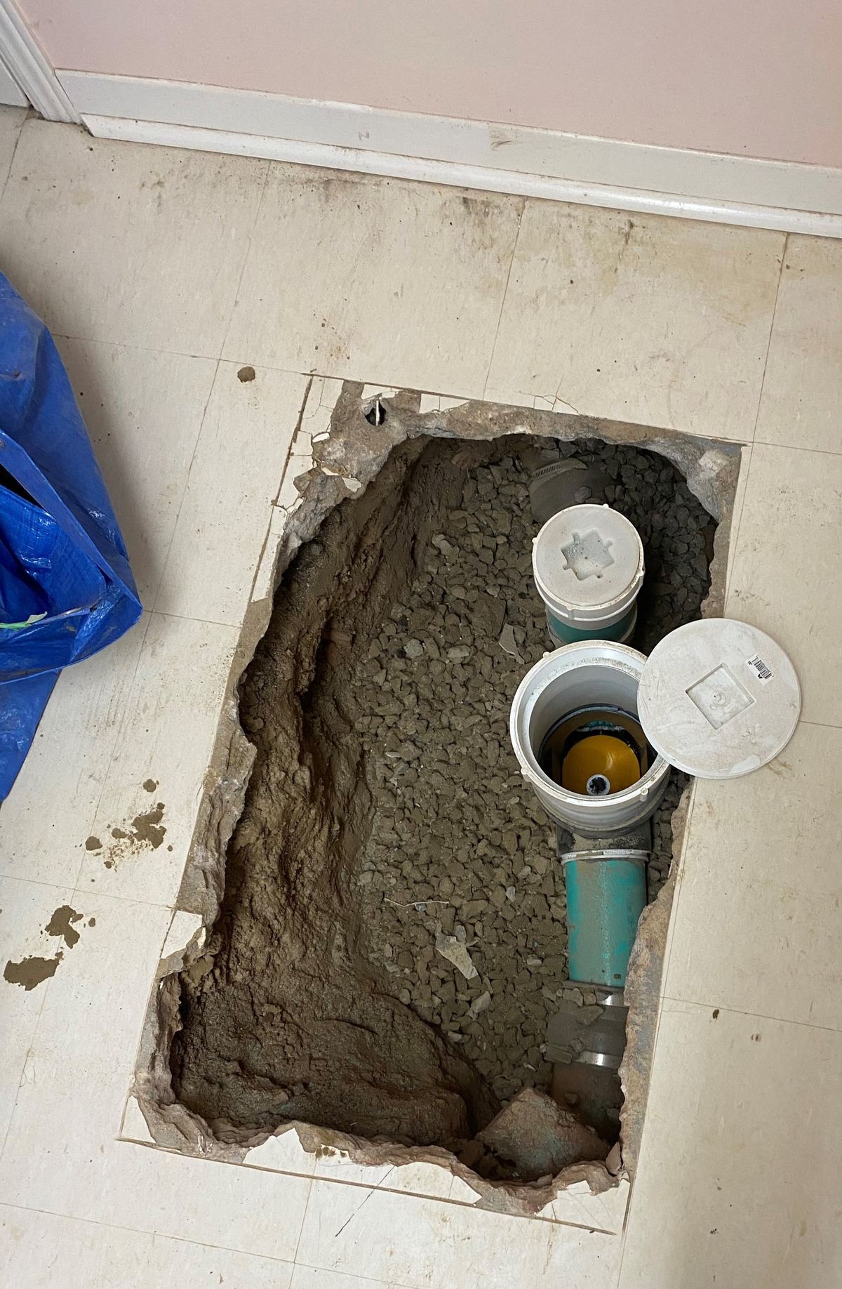Interior backwater valve installed in a Toronto basement floor, cover open